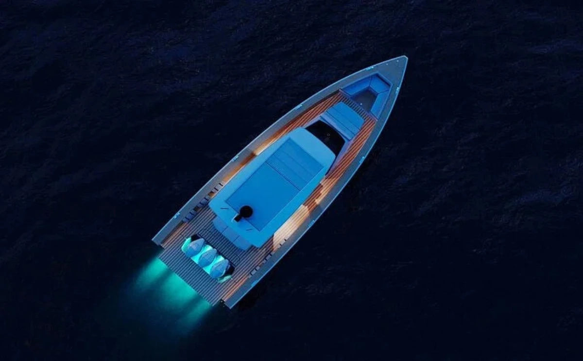 "Nevma" yacht illuminated with soft blue lights cuts through the night waters, showcasing a luxurious and tranquil evening experience on the sea.