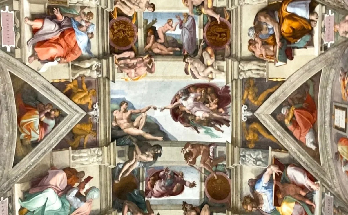 Detailed view of Michelangelo's frescoes on the Sistine Chapel ceiling, featuring vibrant depictions of biblical scenes, including the iconic Creation of Adam in the center.